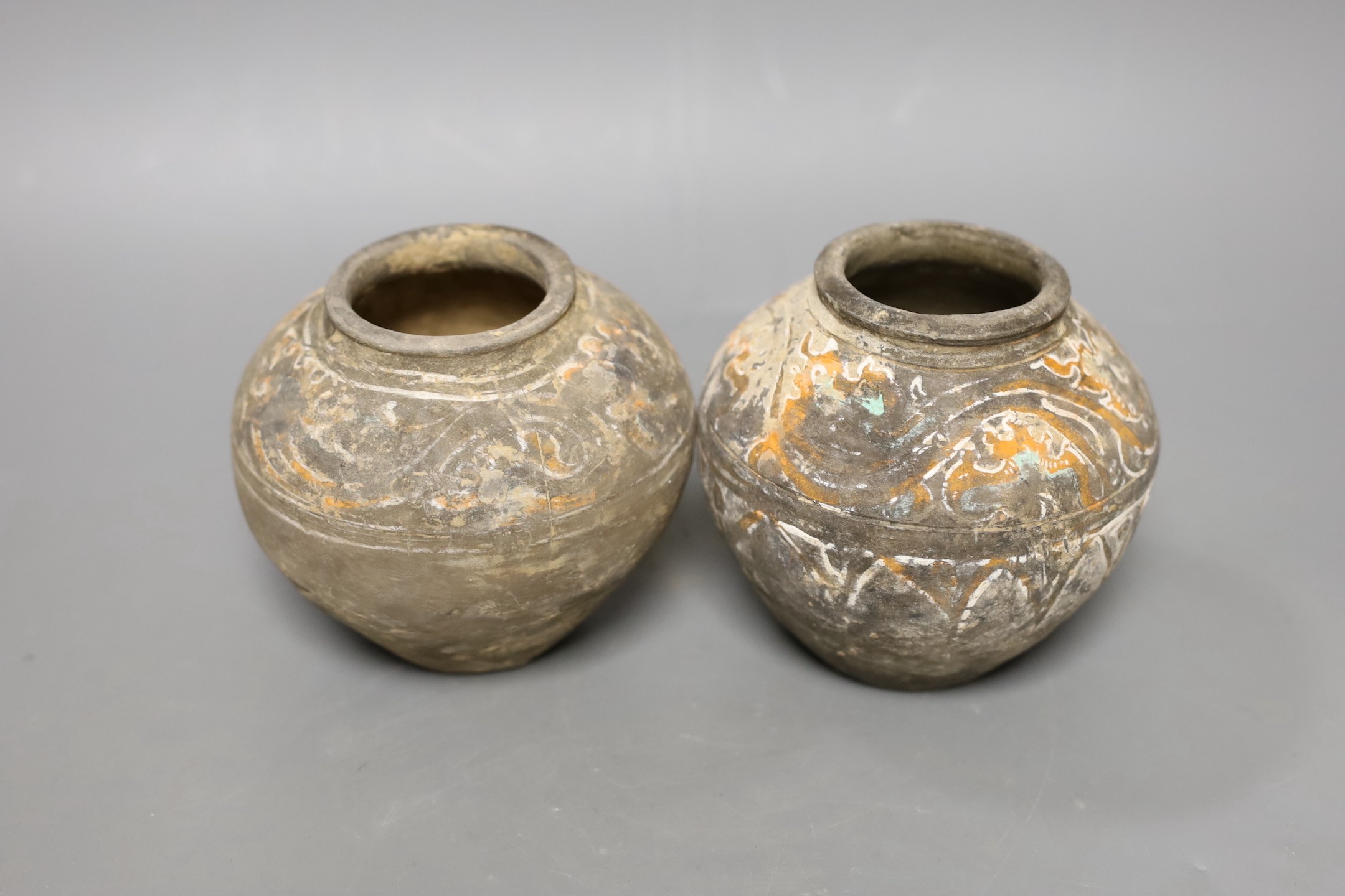 Two Chinese pigment painted grey pottery small jars, Han dynasty (200BCE - 220CE), 11cm high